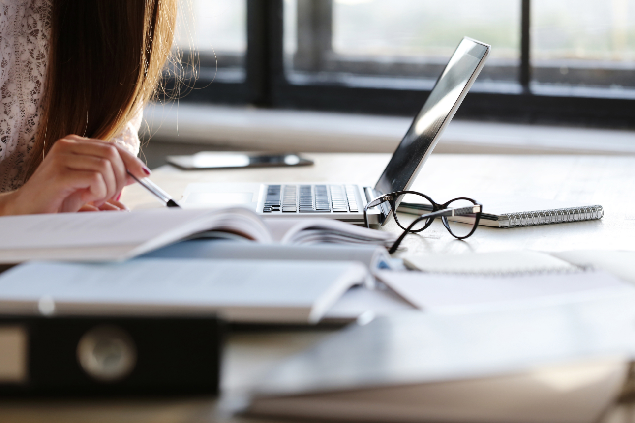 woman working in office with lots of paperwork