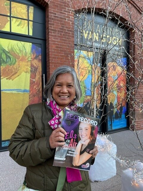 P.E.O. member Gretheline Bolandrina holding a copy of The Record