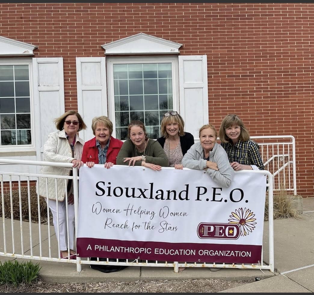 Members of the Siouxland, Iowa Reciprocity Group pose with a sign