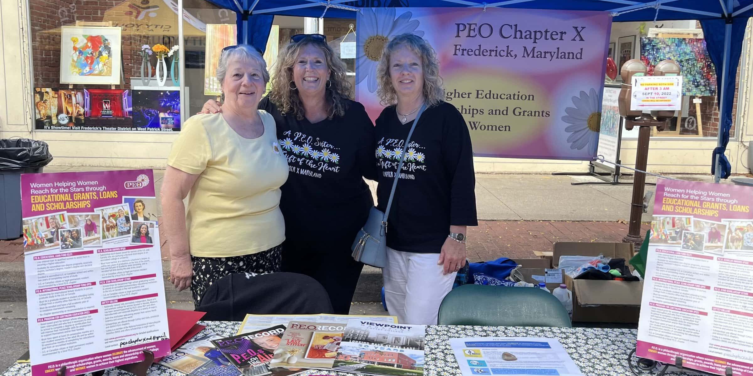 Members of Chapter X, Maryland, with a P.E.O. booth at a local festival