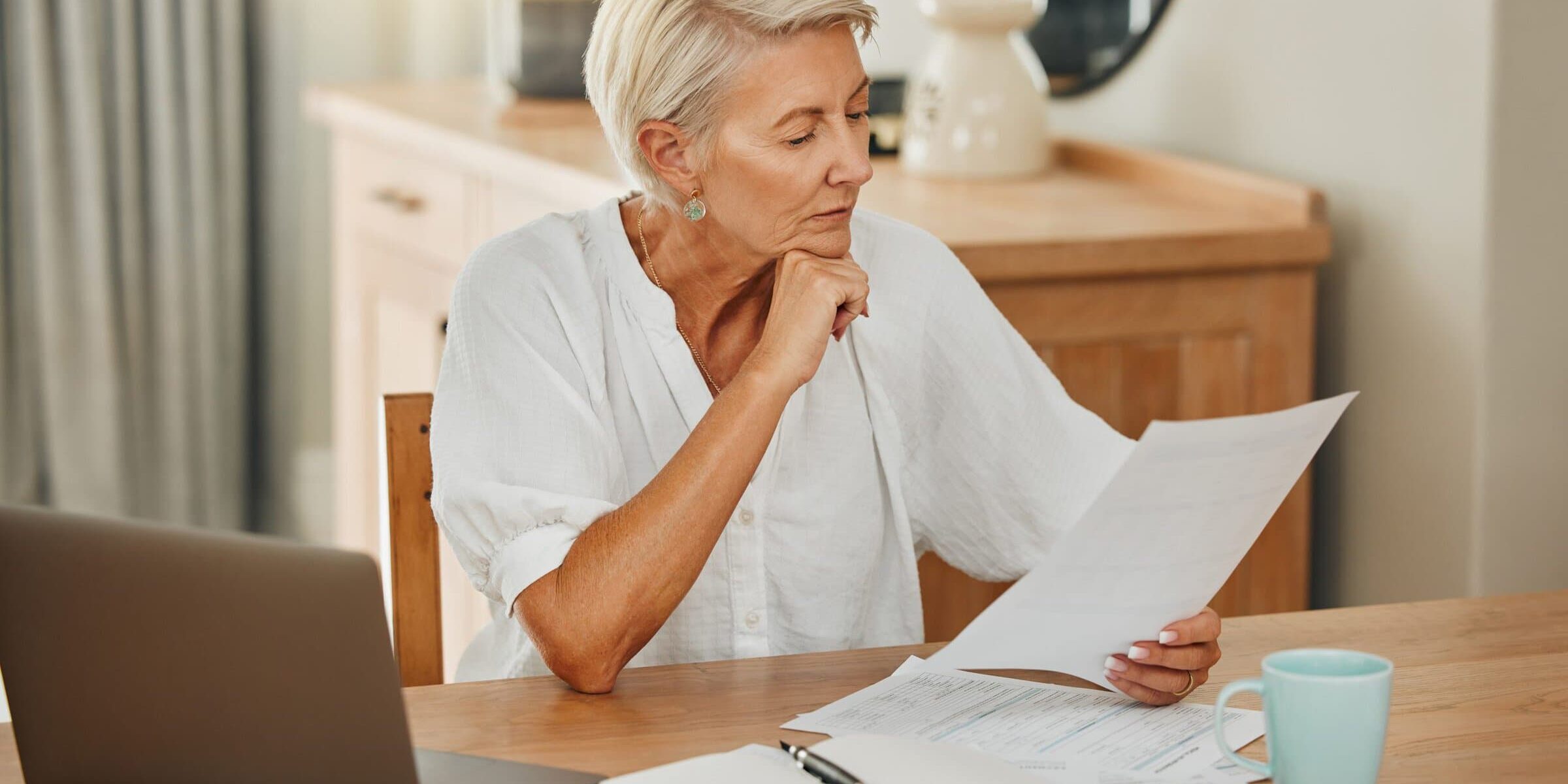 Senior woman looking at financial documents