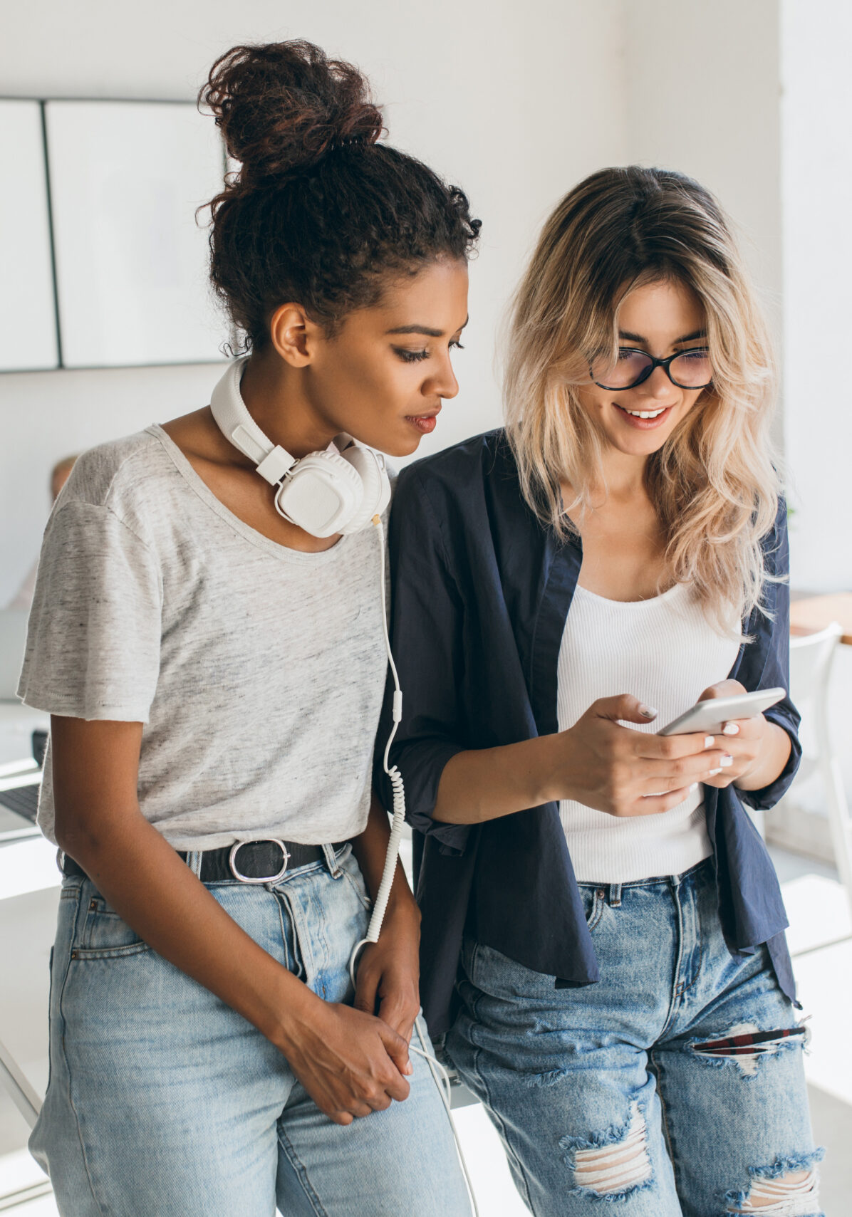 Two female students looking at phone