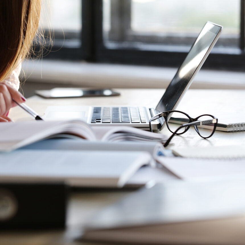 woman working in office with lots of paperwork